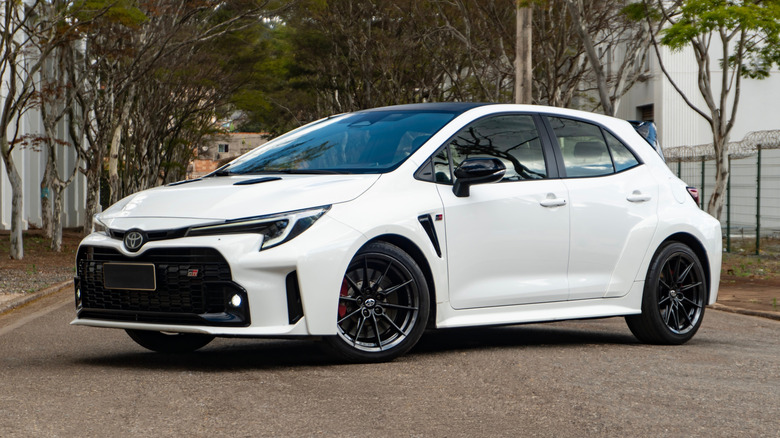 White Toyota GR Corolla on a tree-lined street