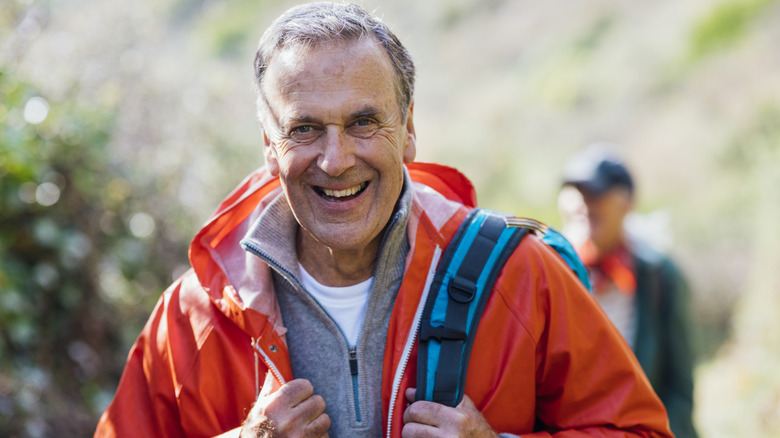 A senior man hiking through the hills in Colorado.