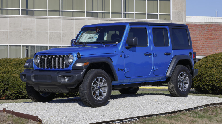 A blue Jeep Wrangler 4-Door Sport 4X4 display.
