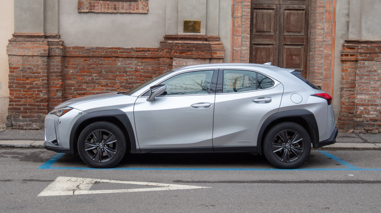 A silver 2026 Lexus UX parked on a street in Italy.