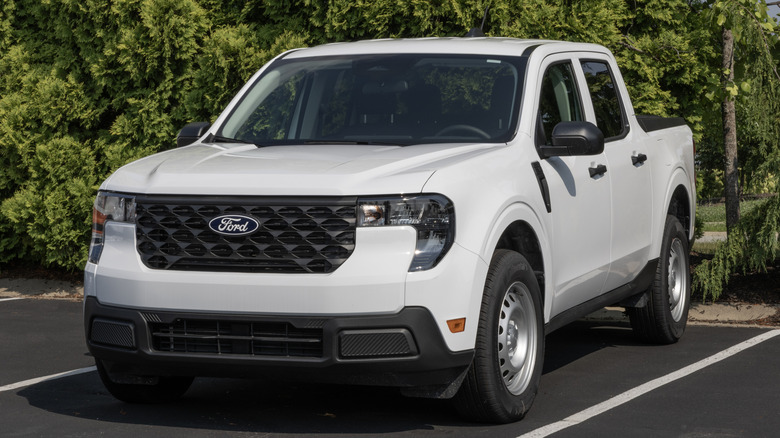 A white Ford Maverick XL Truck display at a dealership.