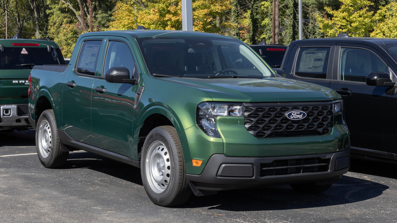 A dark green Ford Maverick XL FWD Hybrid pickup on display.