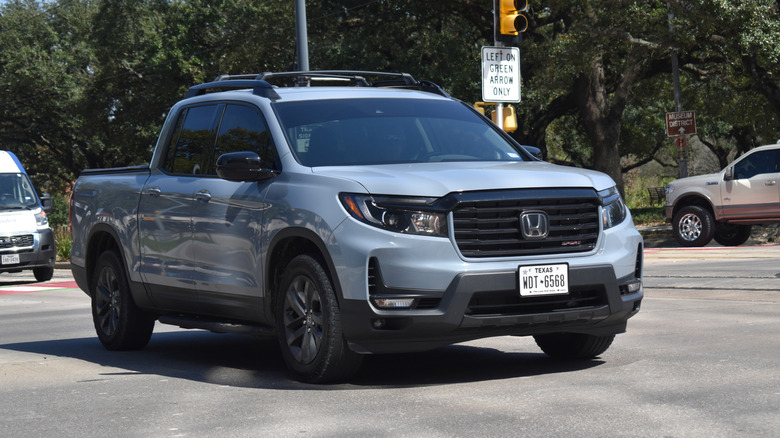 A blue Honda Ridgeline pick-up truck, cruising at an intersection near Hermann Park.