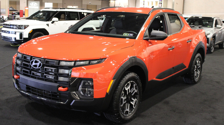 An orange Hyundai Santa Cruz on display.