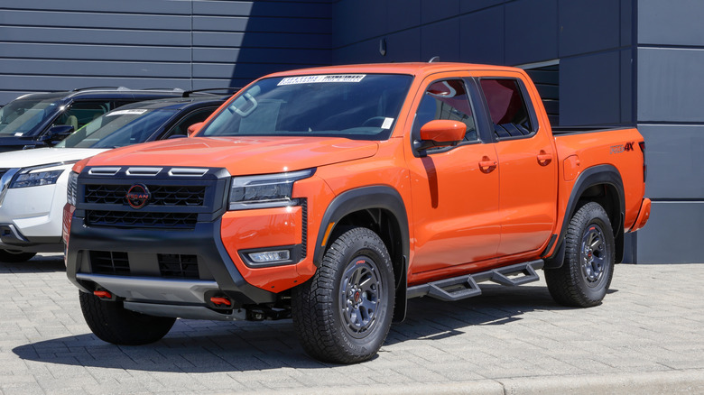 An orange Nissan Frontier on display.