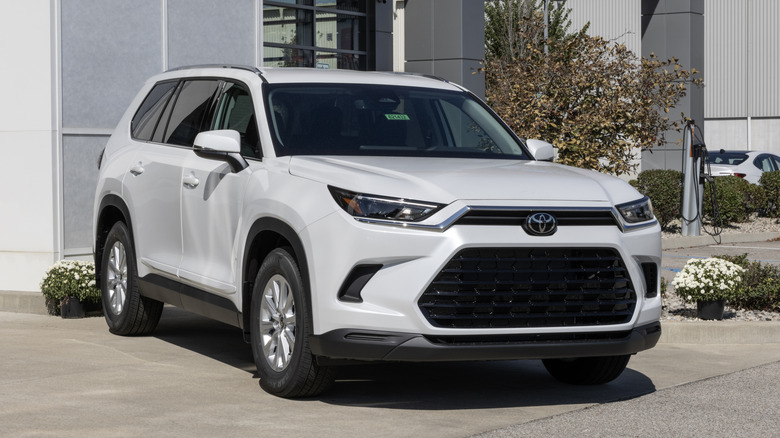 A white Toyota Grand Highlander XLE AWD SUV at a dealership.