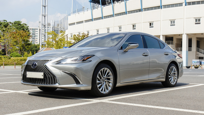 A silver Lexus ES300h hybrid luxury sedan parked in an outdoor parking lot.