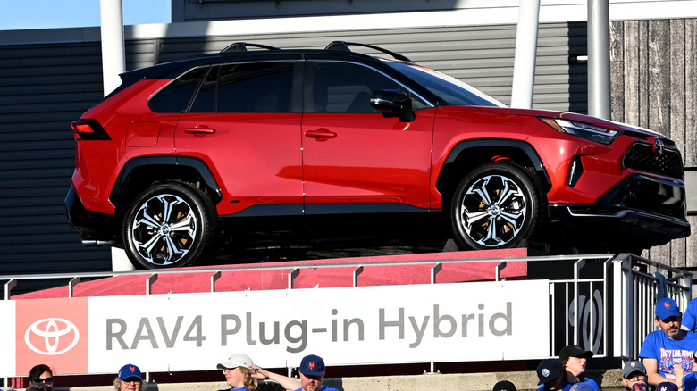 A red Toyota RAV4 Hybrid on display at a New York Mets game.