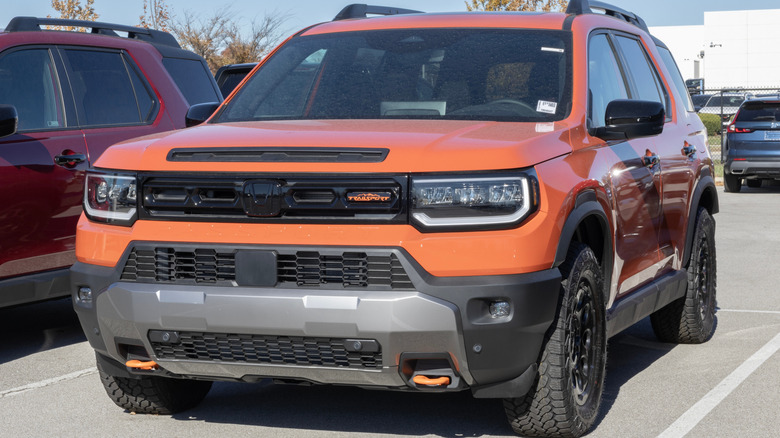 An orange Honda Passport on display.