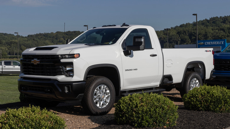 A white Chevrolet Silverado 3500HD on display at a dealership.