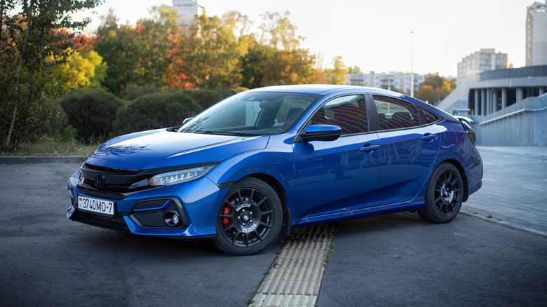 A blue Honda Civic Si parked on the road.