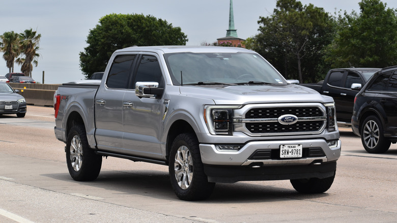 A Ford F-150 driving on a highway.