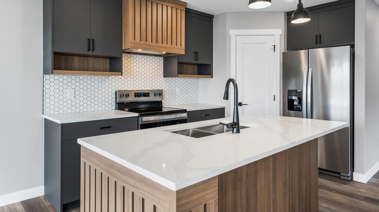 kitchen island clad in walnut toned wood panels