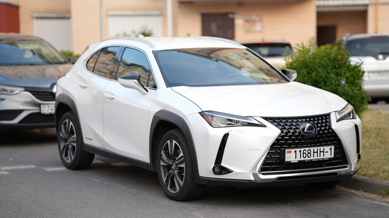 A white Lexus UX parked in the city.