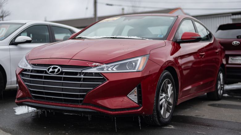 A red 2020 Hyundai Sonata parked in the lot of a dealership