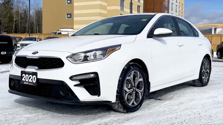 A 2020 Kia Forte EX on a snowy dealership lot