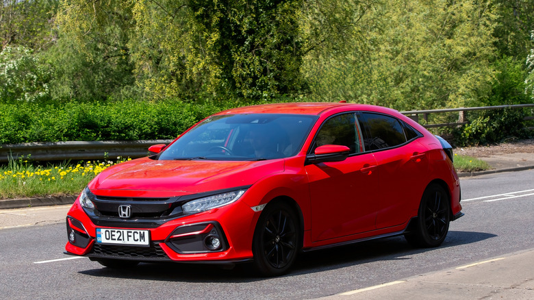 A red 2021 Honda Civic sport car on an English road.
