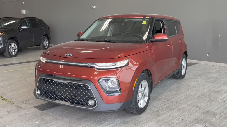 An orange 2021 Kia Soul on display at a dealership