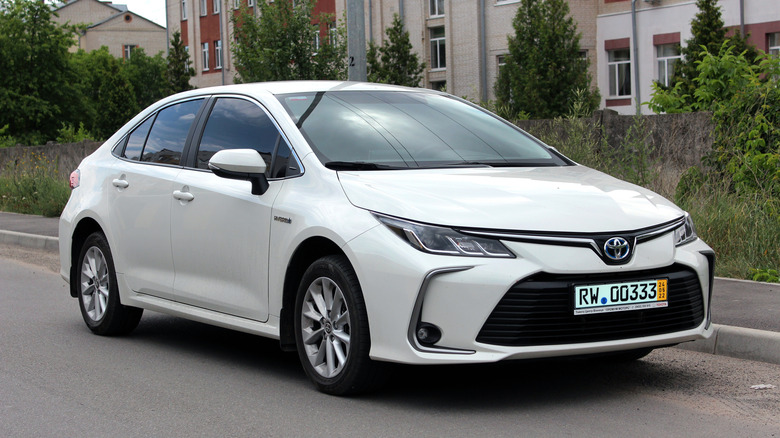 A white 2022 Toyota Corolla hybrid parked on the side of a road