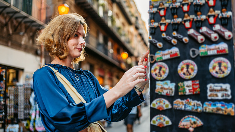 traveler looking at magnets while on vacation
