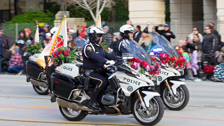 Pasadena police officers on motorcycles in a parade.