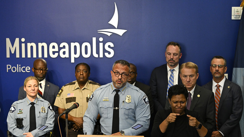 A press conference with several police officers in attendance.