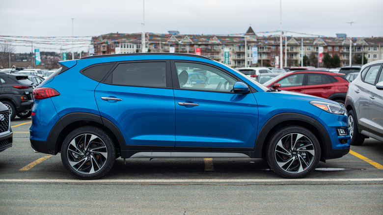 A blue Hyundai Tucson sport utility vehicle at a dealership.