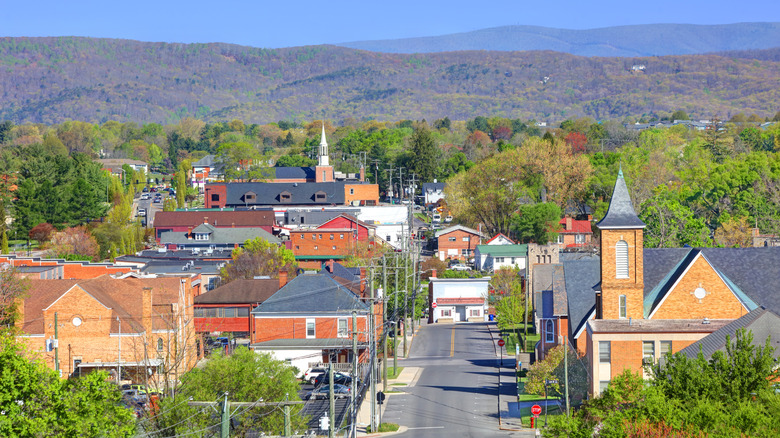 A drone image of Blacksburg, Virginia on a sunny autumn day with rolling mountains in the background