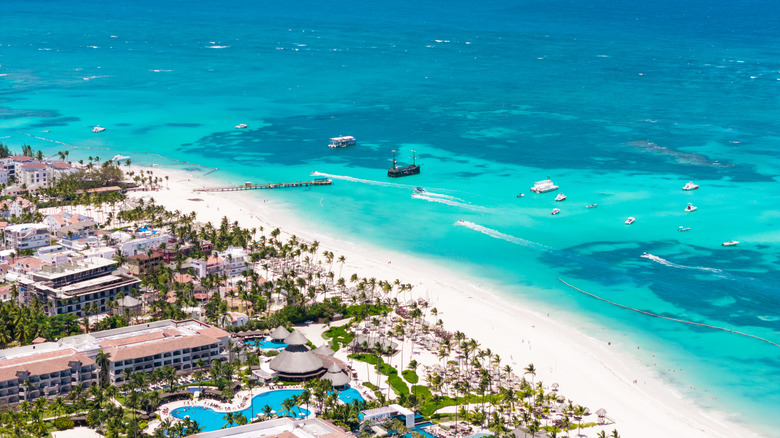 An overhead view of the development of Punta Cana's Corales Beach with a ship offshore