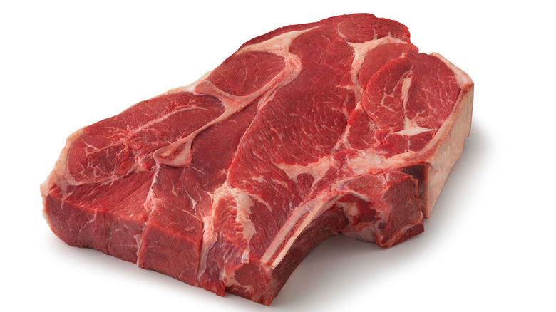 A bone-in chuck steak isolated against a white background.