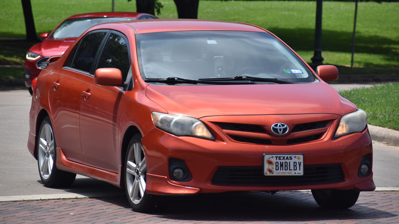 A Toyota Corolla cruising near Herman Park in Houston