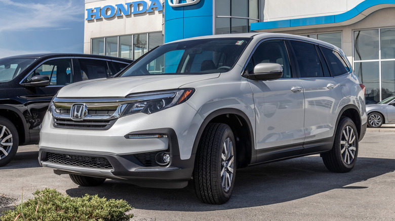 A white Honda CR-V on display outside of a dealership.