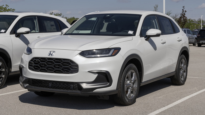 A white Honda HR-V AWD LX Compact SUV Crossover SUV outside on a sunny day.