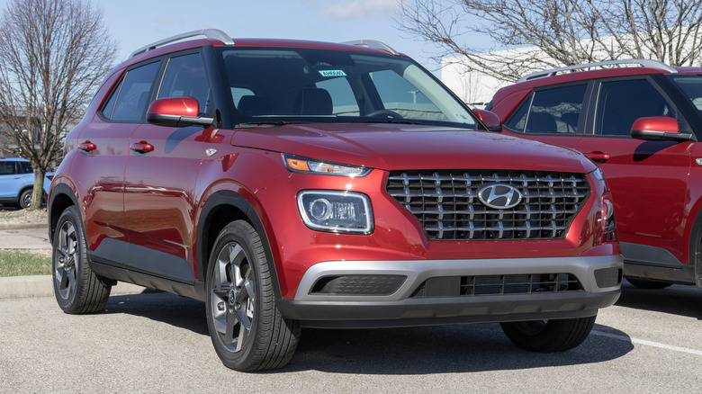A red Hyundai Venue Limited on display at a dealership.