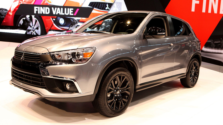 A gray Mitsubishi Outlander Sport Limited Edition on display at an indoor exhibition.