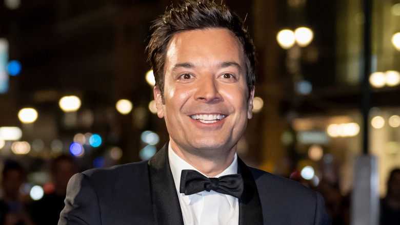 Jimmy Fallon smiling while wearing a black tuxedo