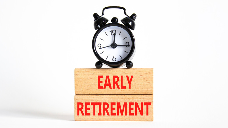 Wooden blocks with the words Early Retirement, and a clock sitting on top.