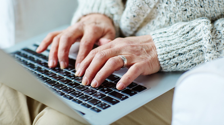 Older woman registering for Medicare on a laptop