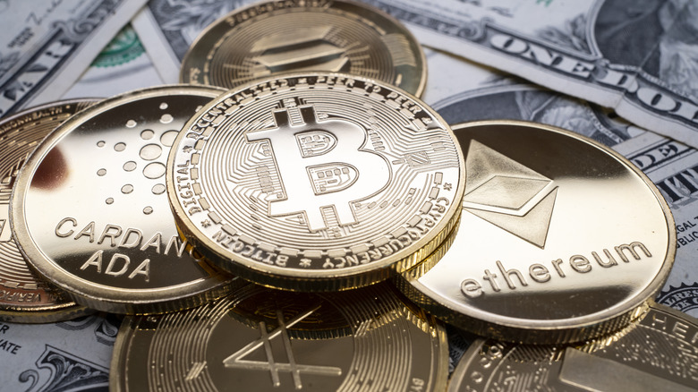 Different cryptocurrency coins on cash.