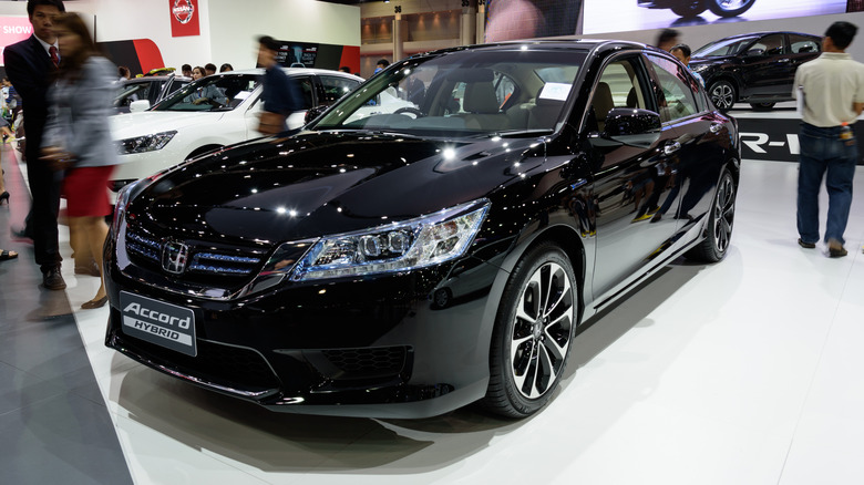 A black 2015 Honda Accord Hybrid on display at a car show