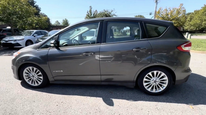 A gray 2018 Ford C-Max Hybrid in a dealership parking lot