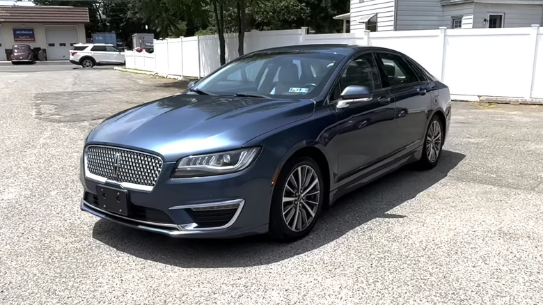 A blue 2018 Lincoln MKZ Hybrid in a parking lot on a sunny day