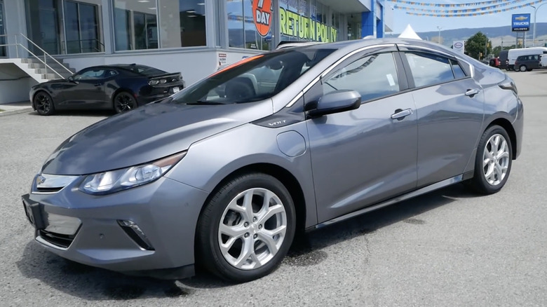 A silver 2019 Chevrolet Volt parked outside of a dealership