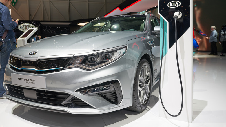 A 2019 Kia Optima SW Hybrid plugged in at a car show