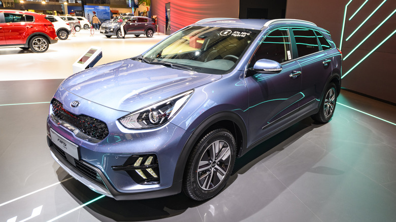 A blue 2020 Kia Niro Hybrid on display at a car show