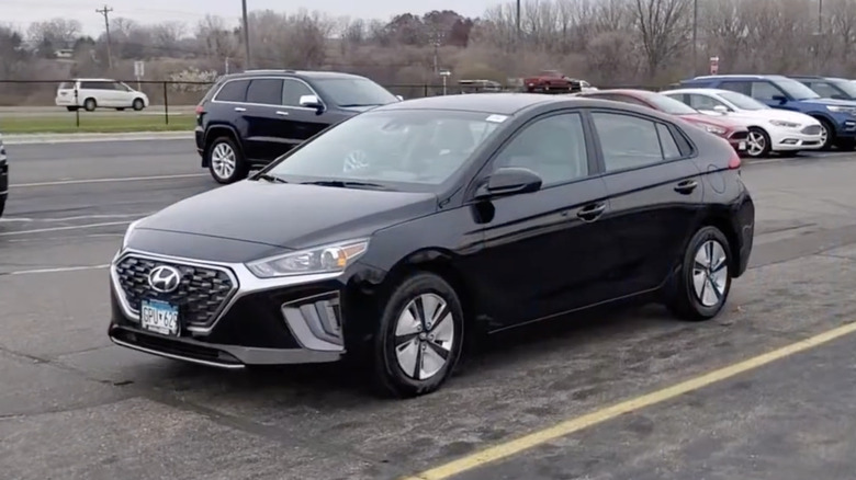 A black 2021 Hyundai Ioniq Hybrid Blue Hatchback in a dealership parking lot