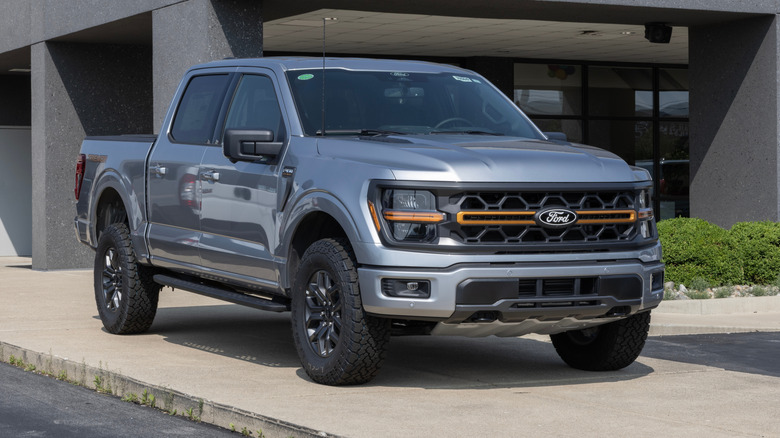 Ford F-150 Tremor 4X4 Supercrew pickup display at a dealership.