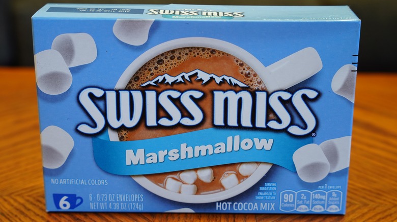 A box of Swiss Miss with marshmallows sitting on a wooden table
