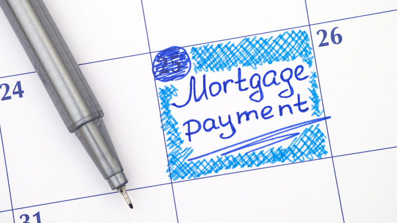Reminder Mortgage Payment in calendar with blue pen.