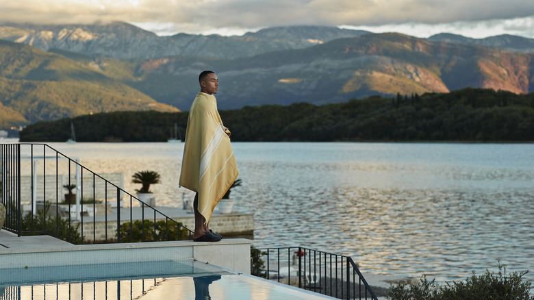 man on a luxurious vacation wrapped in a pool towel